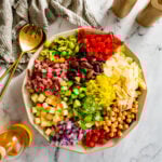 Colorful, unmixed ingredients for Italian chopped salad in a large bowl.