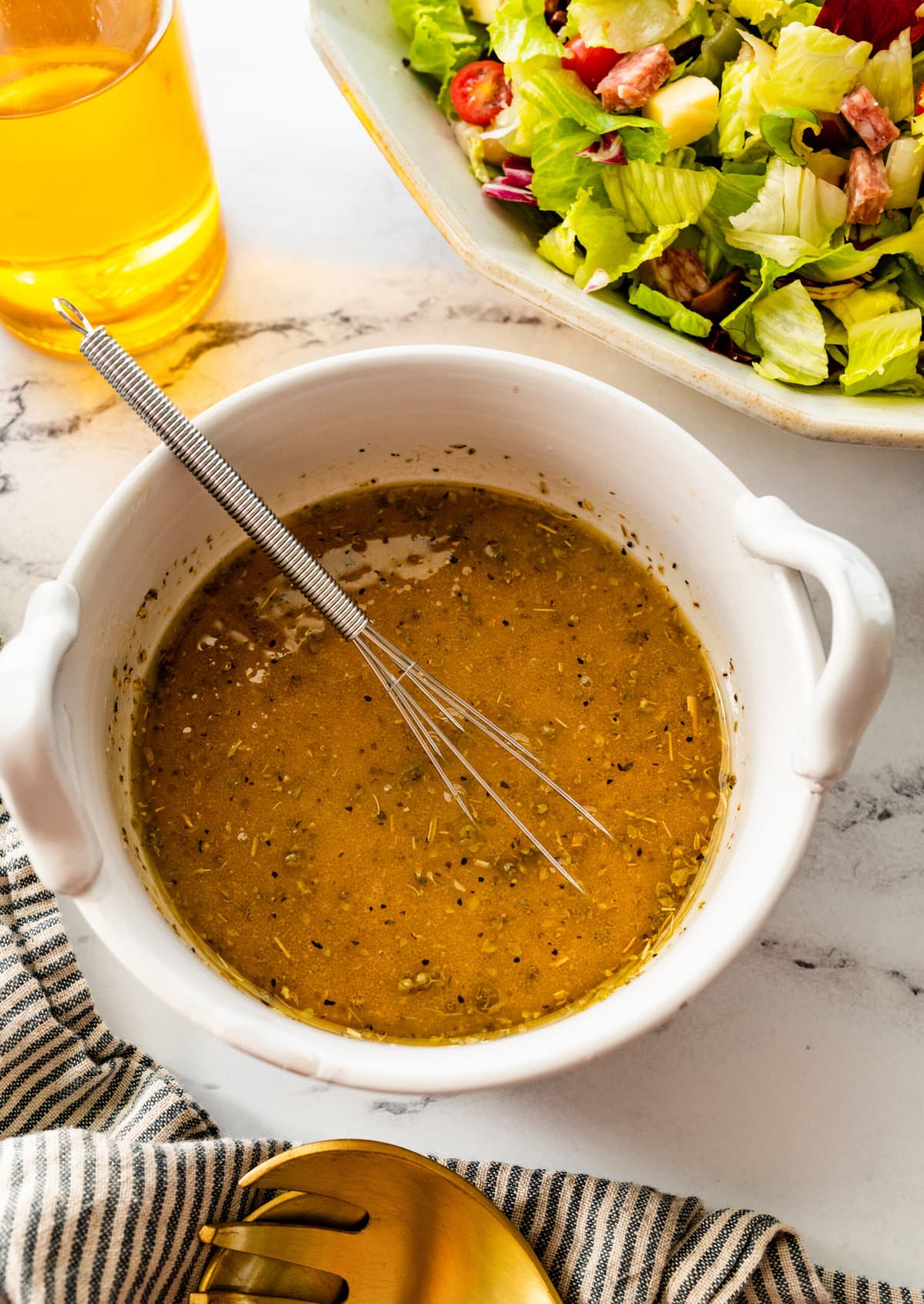 how to make Italian chopped salad step-by-step: salad dressing mixed with a whisk to combine.