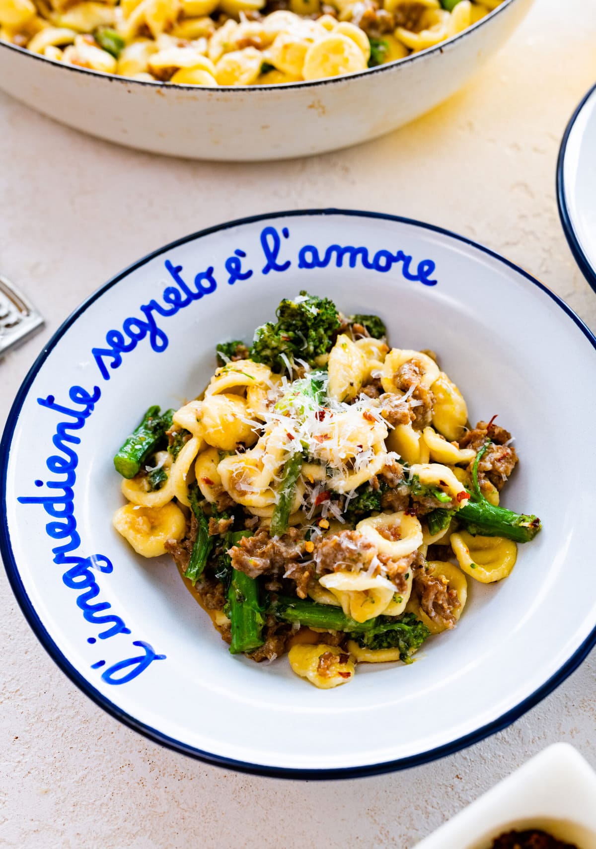 portion of orecchiette pasta dish in a white and blue Italian bowl.