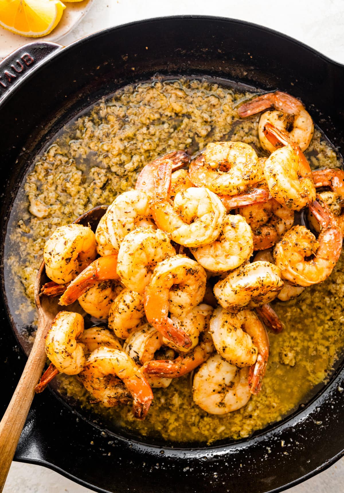 How to make easy pan seared shrimp step-by-step: adding the shrimp back to the cast iron skillet.
