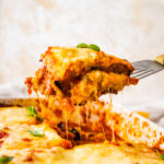 slice of eggplant parmigiana lifted out of the pan with a cheese pull.