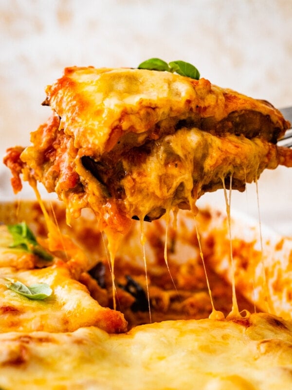 Spatula taking a slice from eggplant parmigiana.