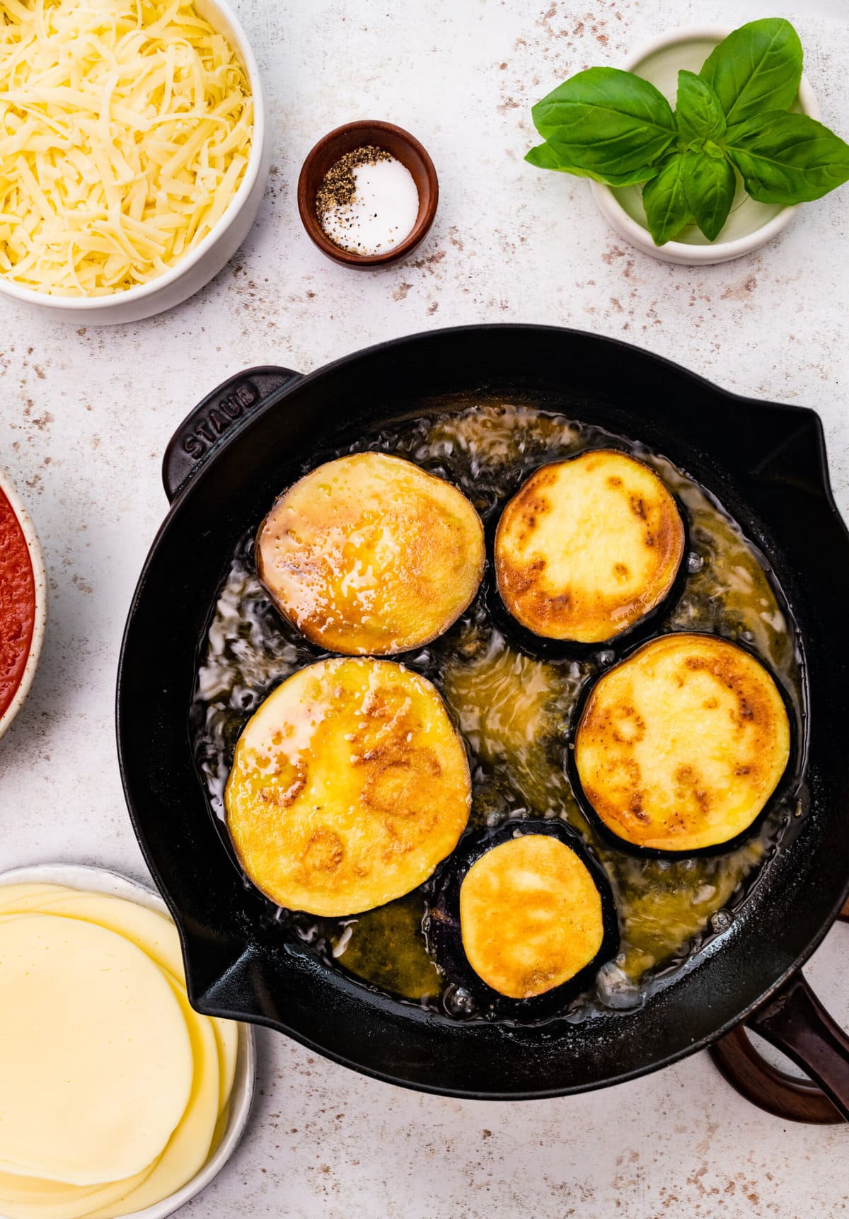 how to make eggplant parmigiana step-by-step: frying the eggplant on both sides in olive oil.