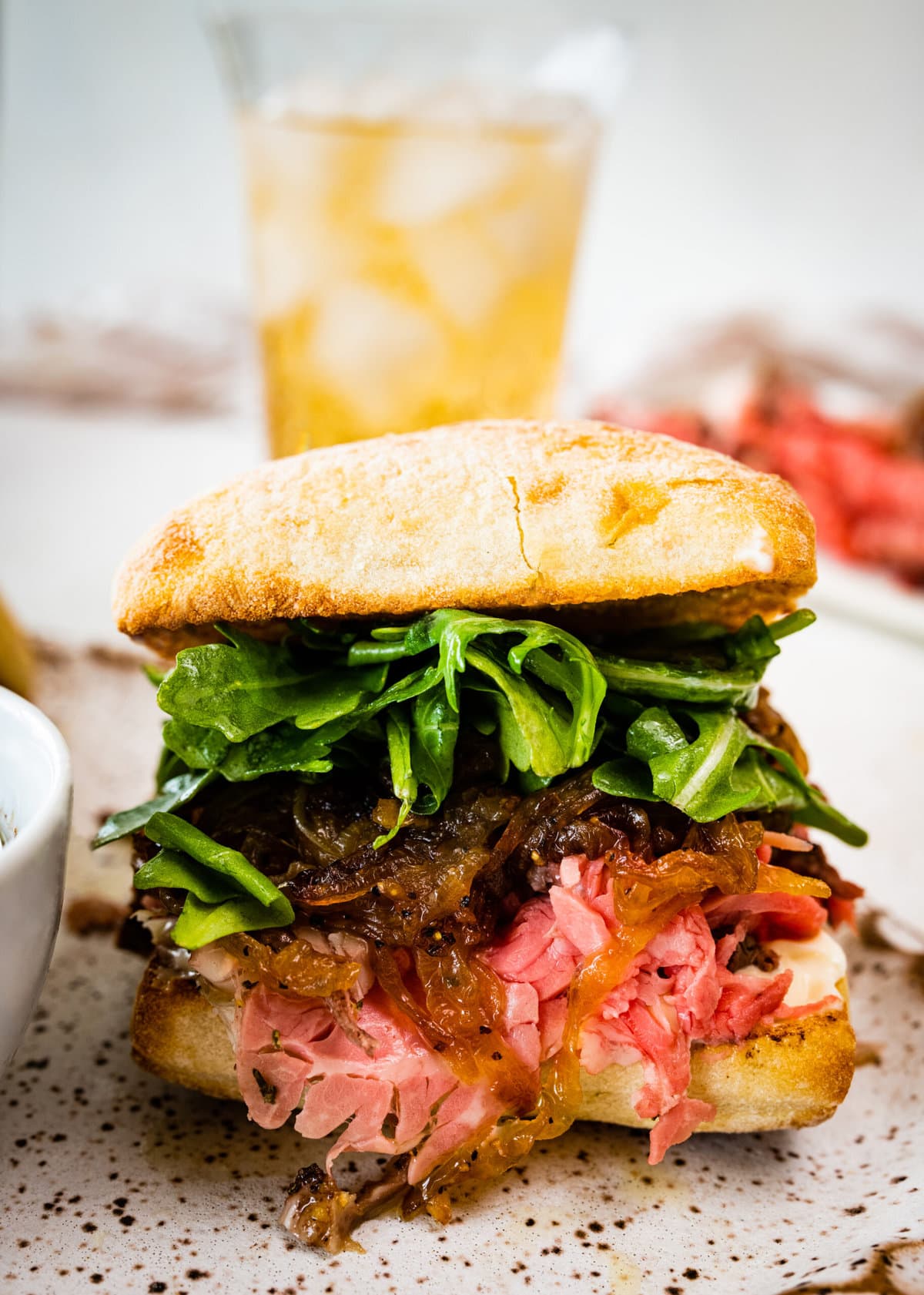 up close photos of the prime rib sandwich with all the toppings.