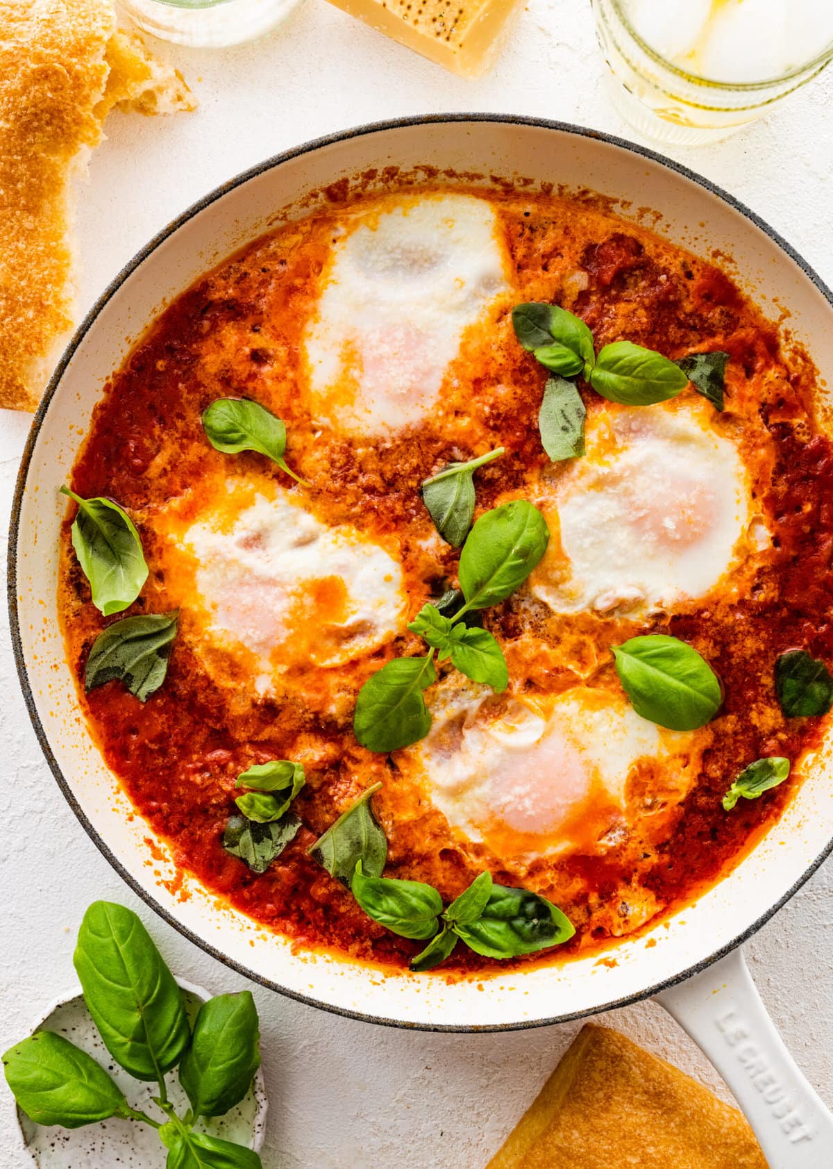 finished eggs in purgatory dish with extra basil as a garnish.