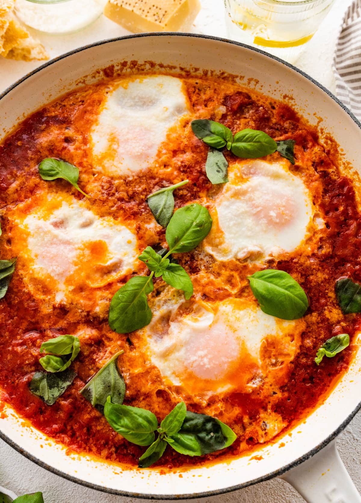 finished eggs in purgatory dish with extra basil as a garnish.