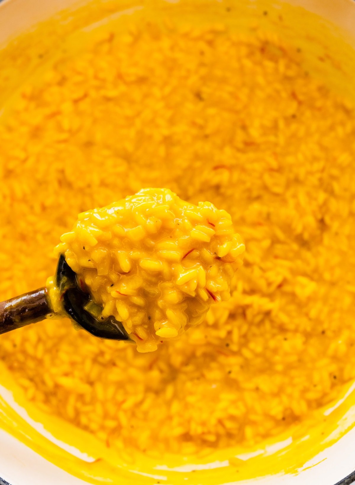 How to make risotto alla milanese step-by-step: stir in the cheese and butter to combine.