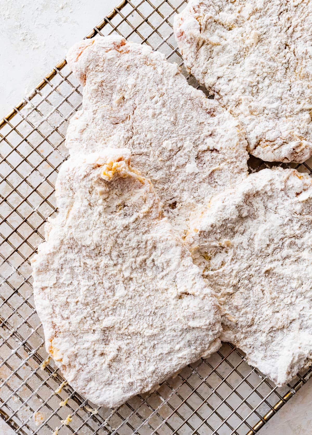 How to make crispy fried pork chops (step-by-step instructions)- coating in flour again before frying.