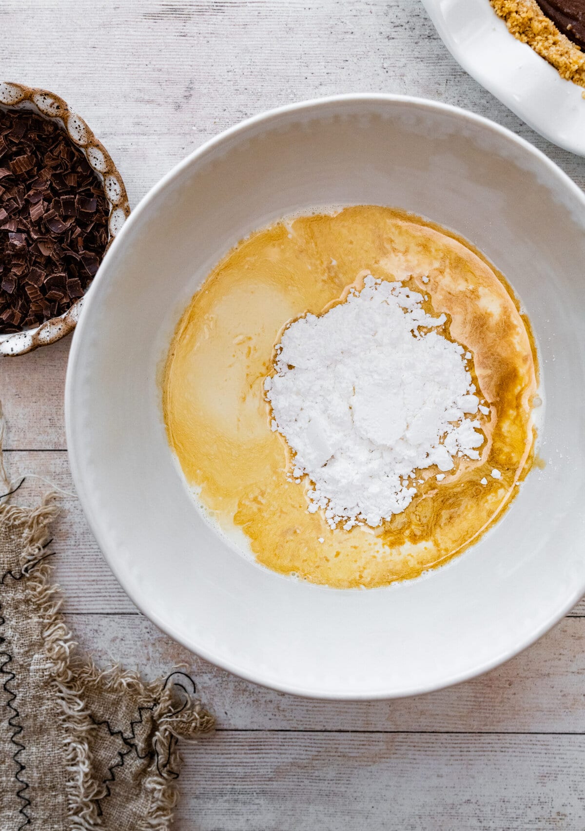 How to make homemade chocolate pudding pie step-by-step: tempering the egg yolks.