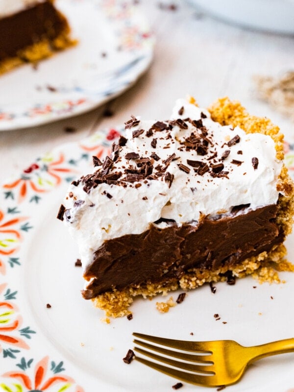 Slice of chocolate pudding pie on a plate with a fork.