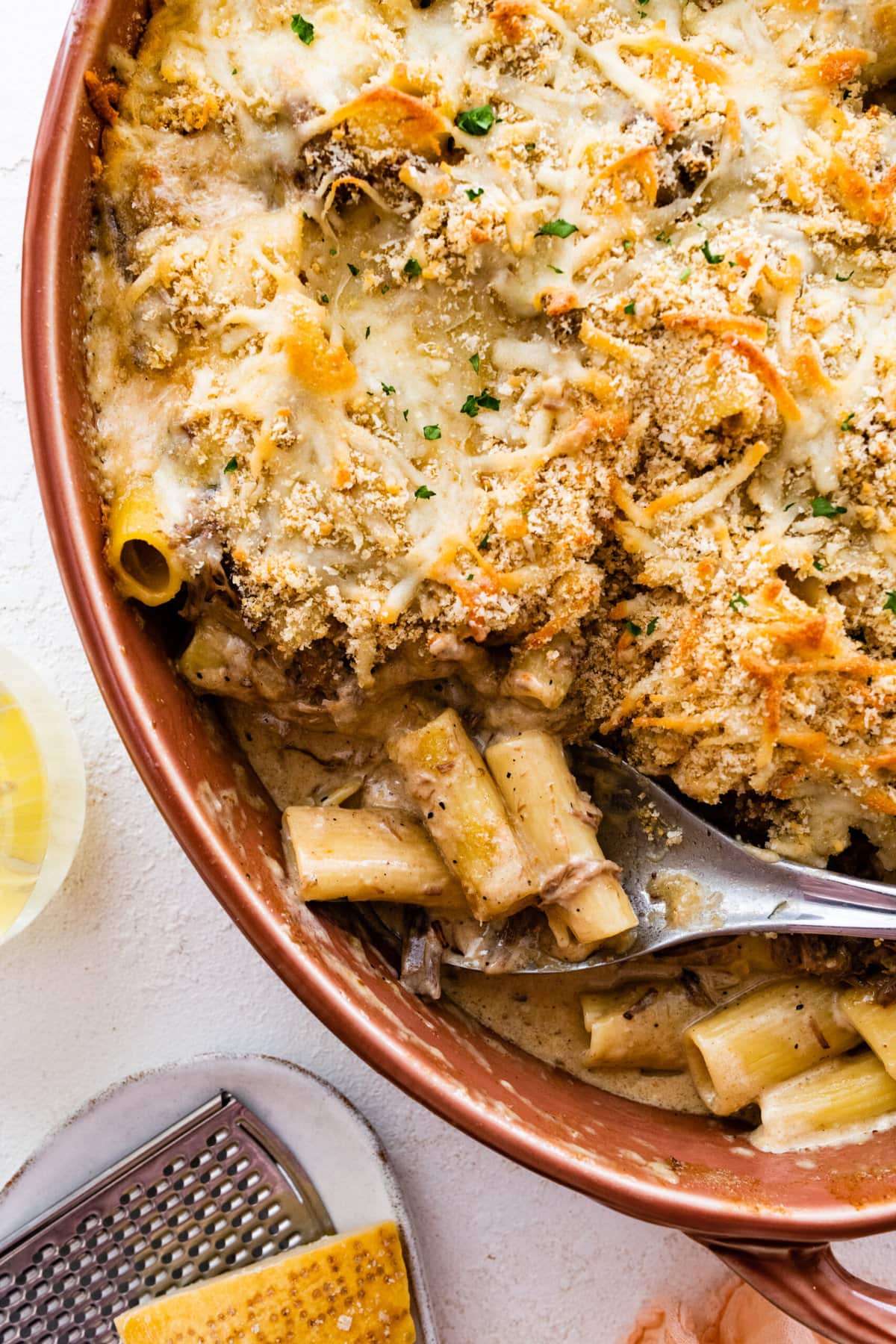 serving spoon in pan with of the delicious pasta casserole.