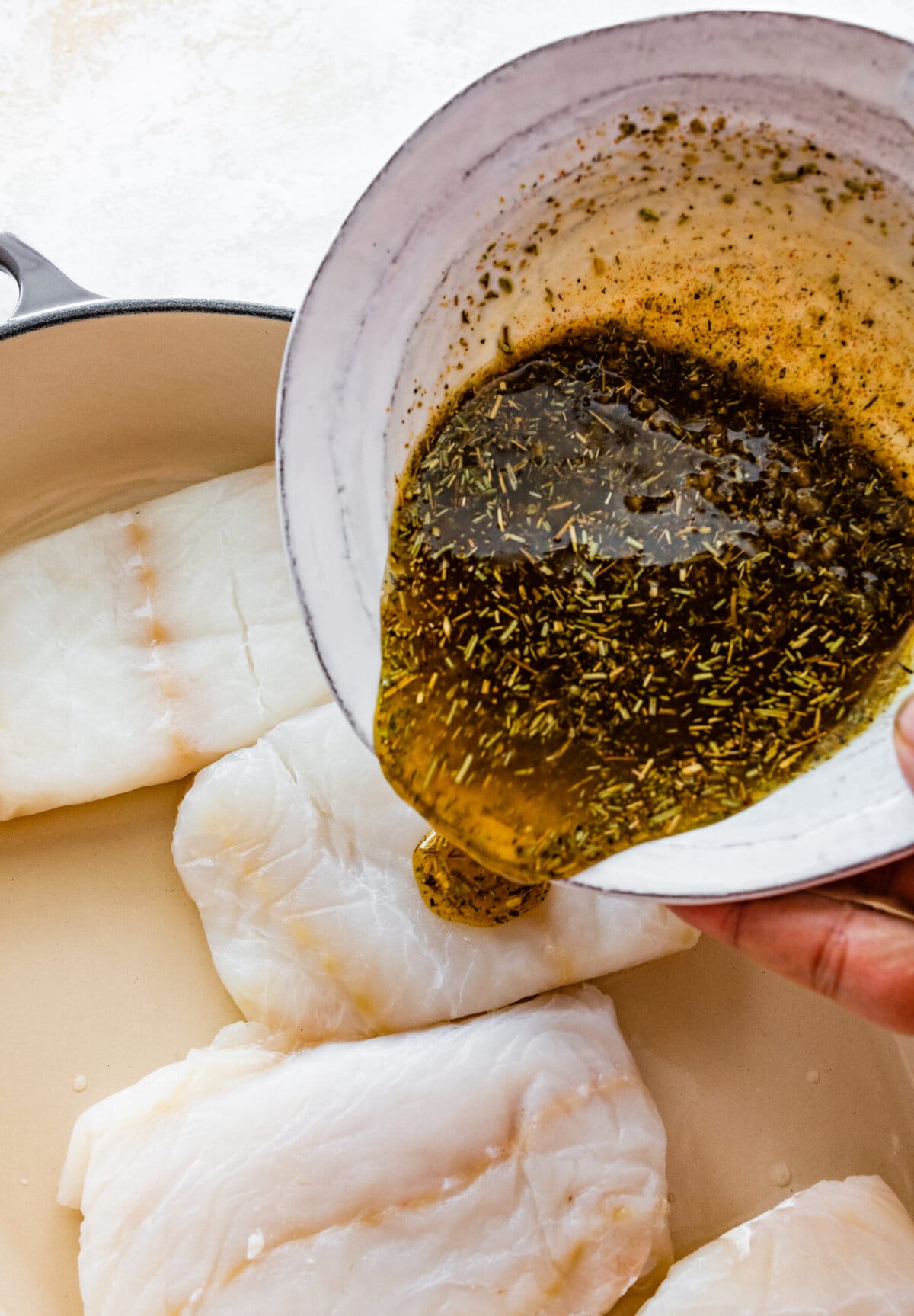How to make easy oven baked cod step-by-step instructions: pour marinade on fish.