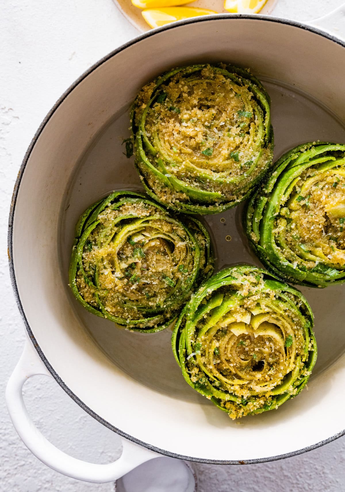 how to make stuffed artichokes step-by-step photos- placing artichoke in pot with water to cook.