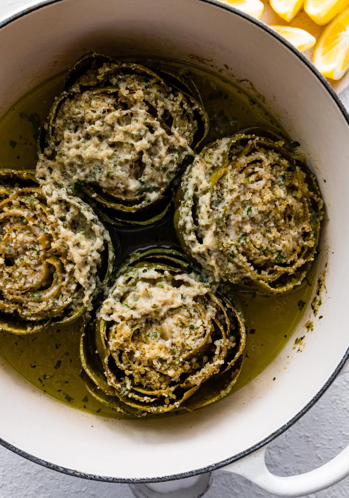 how to make stuffed artichokes step-by-step photos- cooked artichokes in pot with filling.