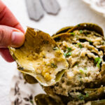 eating a piece of the artichoke with the filling in it.