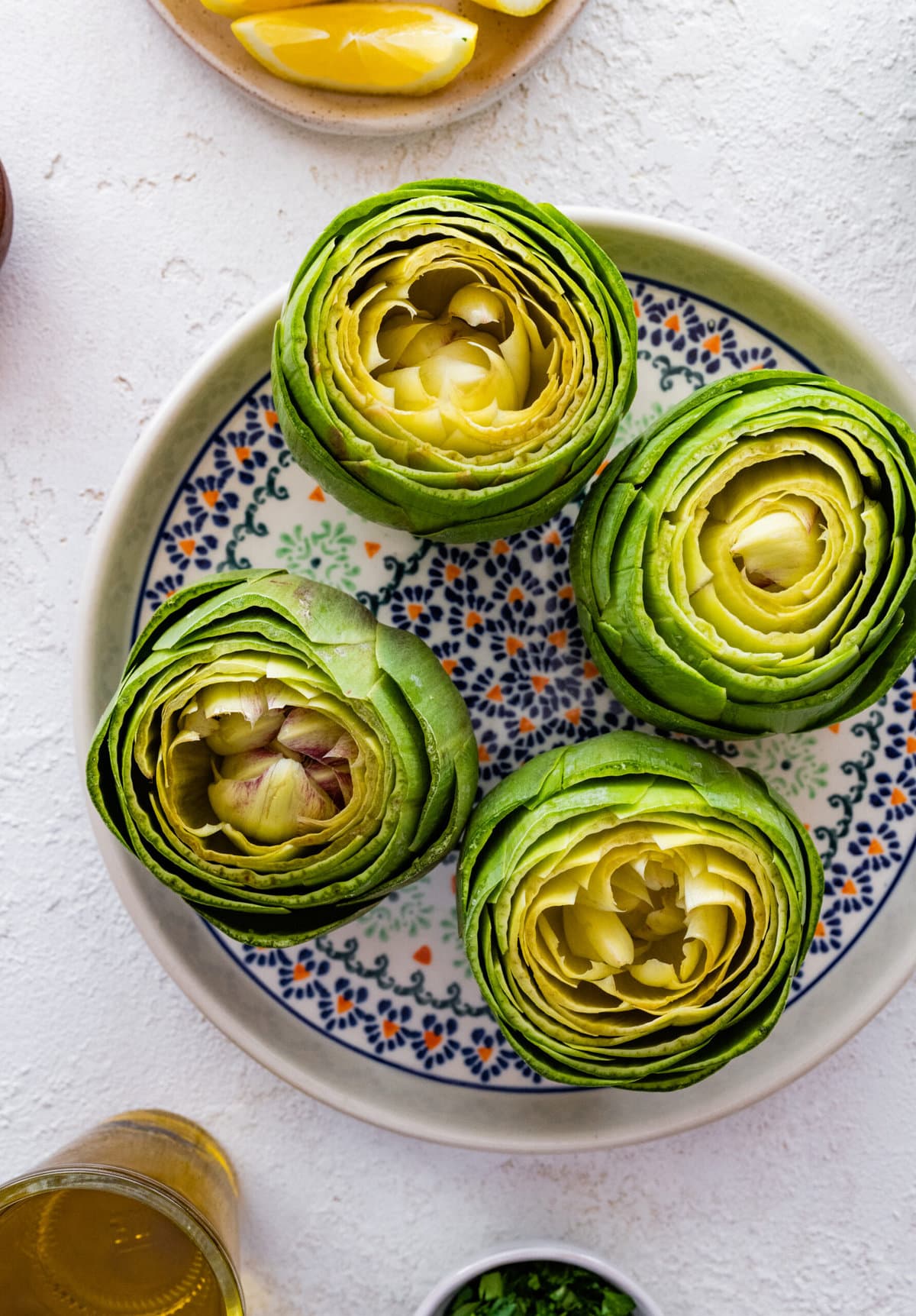 how to make stuffed artichokes step-by-step photos- taking off the outer layers of the artichoke.