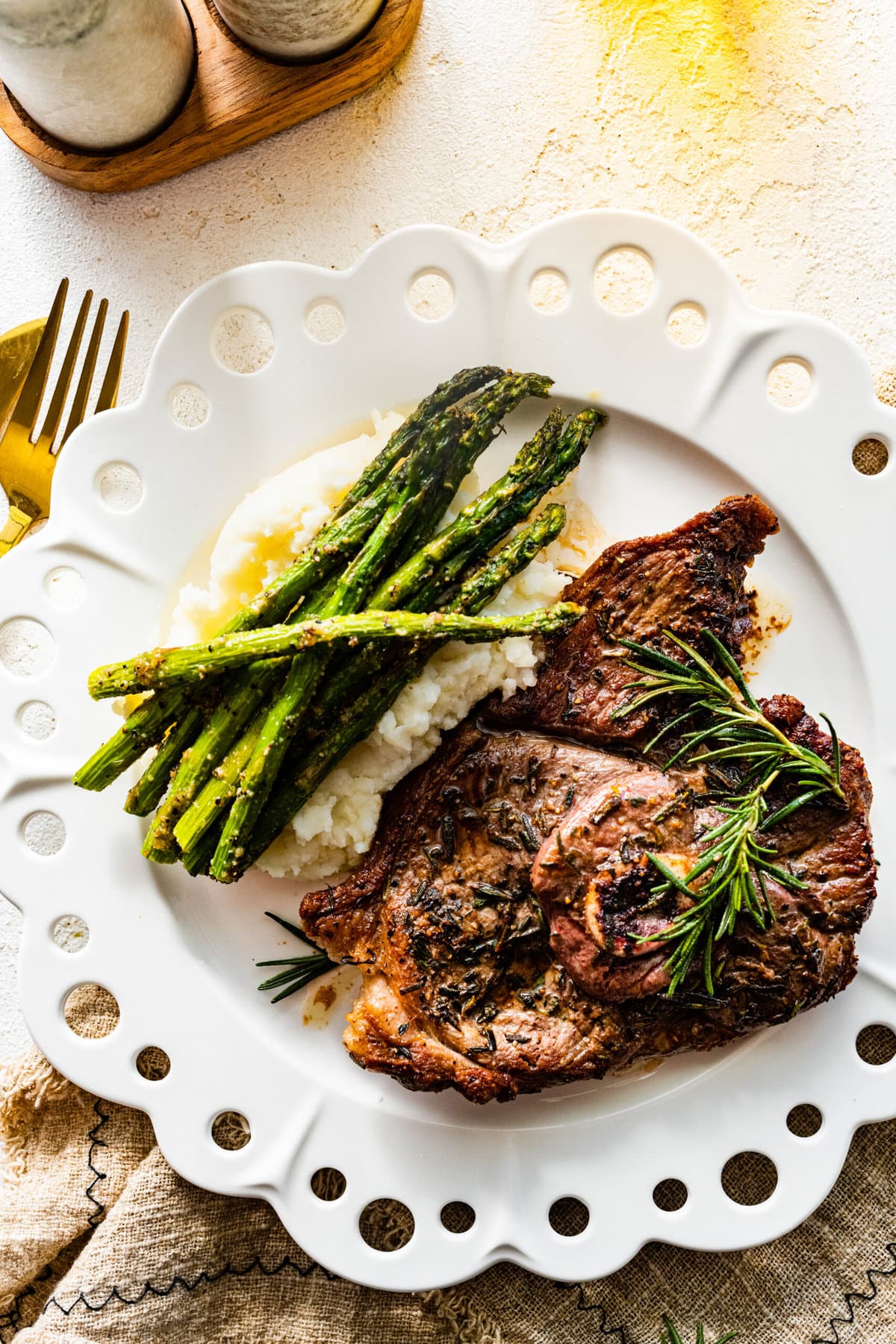 lamb steak on a plate with asparagus.