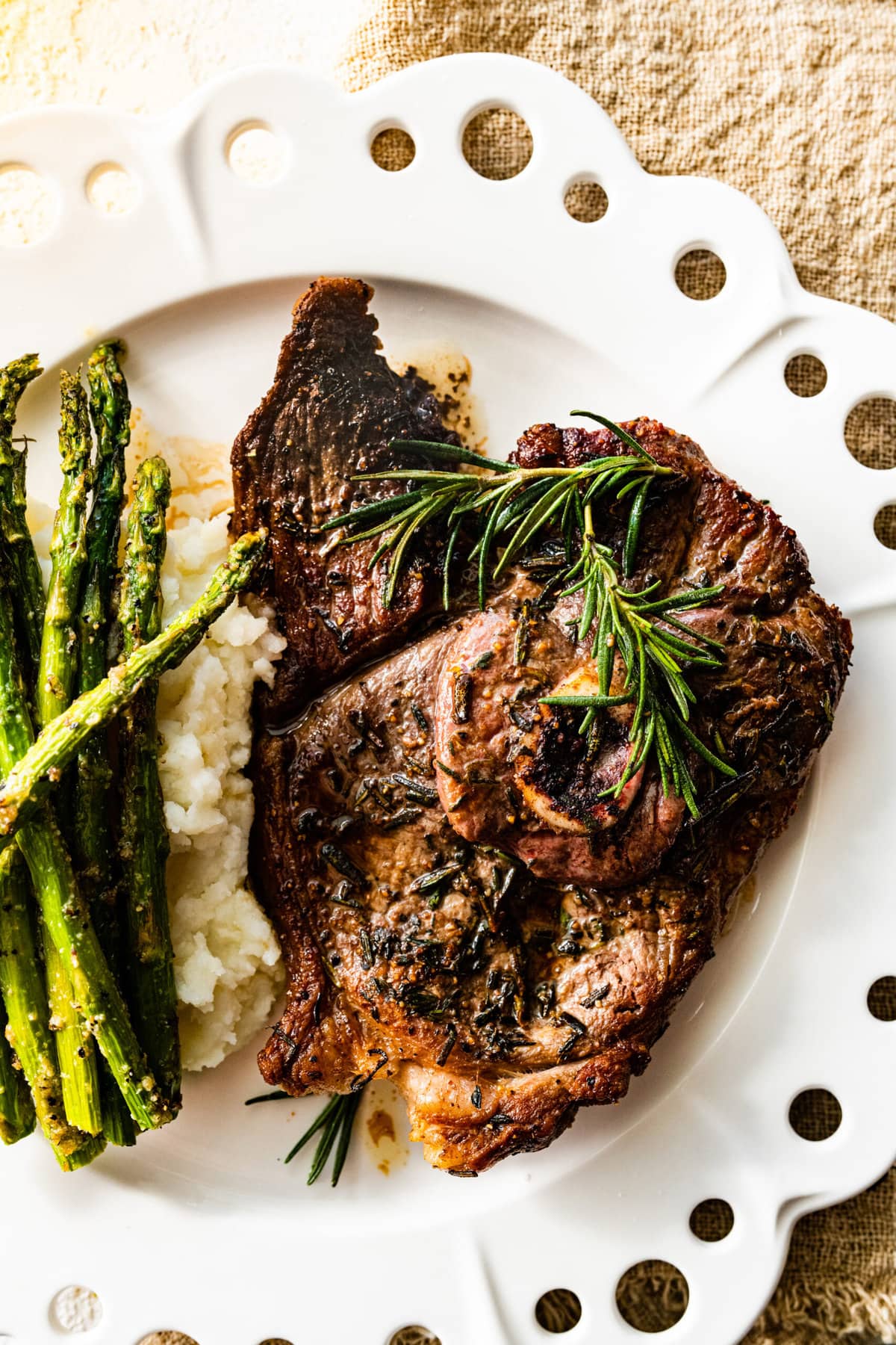 lamb steak on a plate with asparagus.