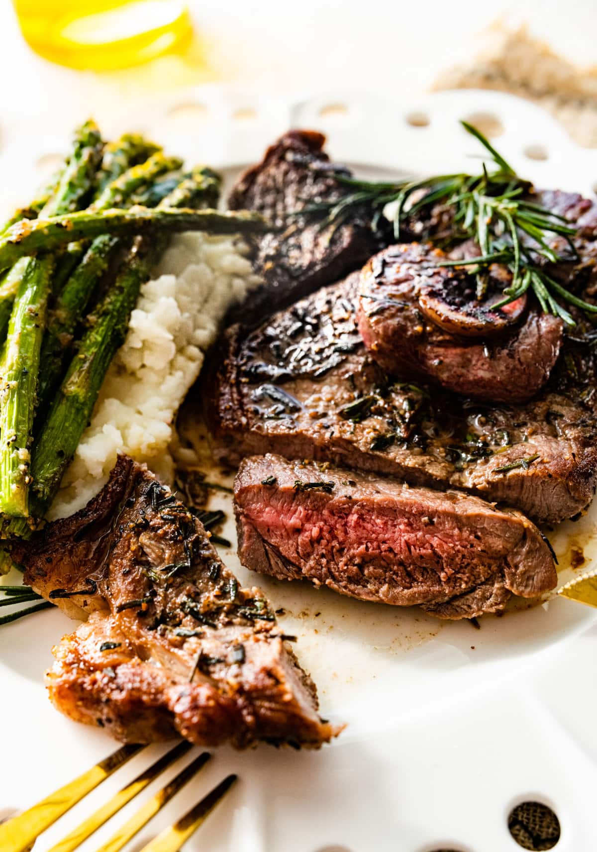 lamb steak on a plate with asparagus. Sliced meat on plate.
