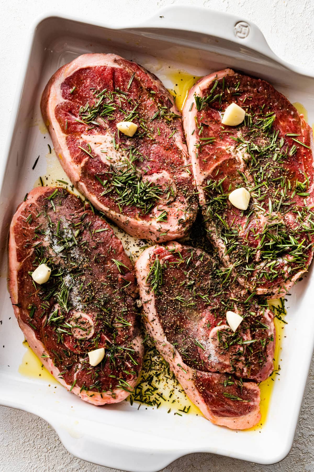 How to make lamb should chops step-by-step: marinating the lamb chops in herbs, garlic, and olive oil.