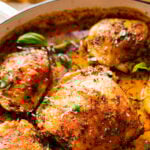 close up of baked chicken thighs in sauce.