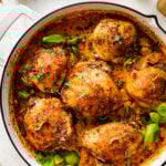 Baked chicken thighs in a white pan.