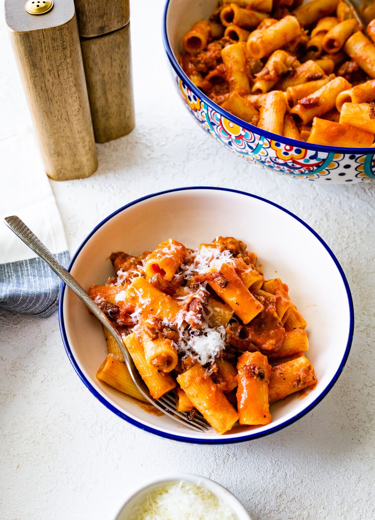 bowl of pasta alla zozzona recipe with the big serving Italian-style bowl of pasta in the background.