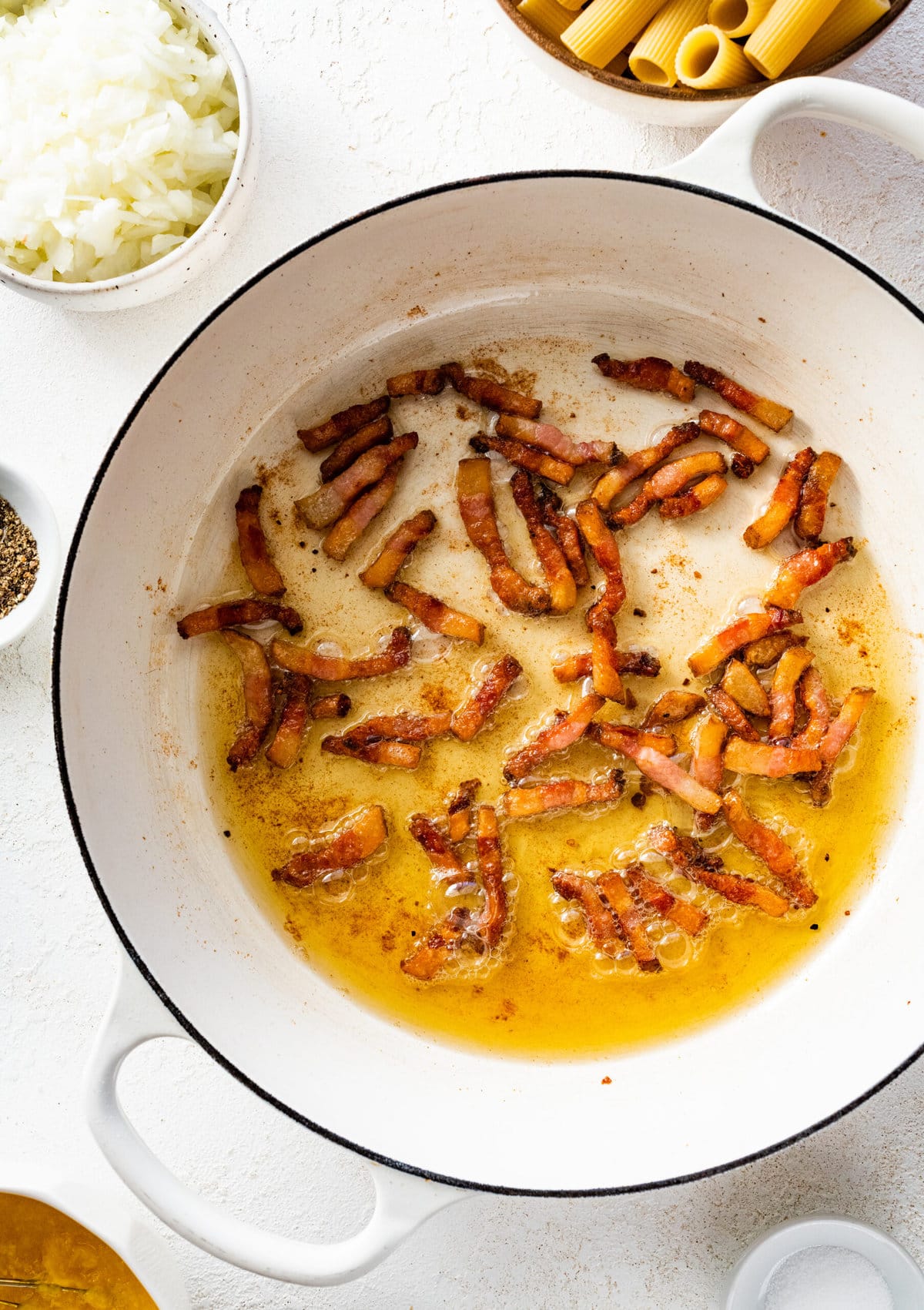 how to make pasta alla zozzona recipe instructions- frying the pancetta in a pan with oil.