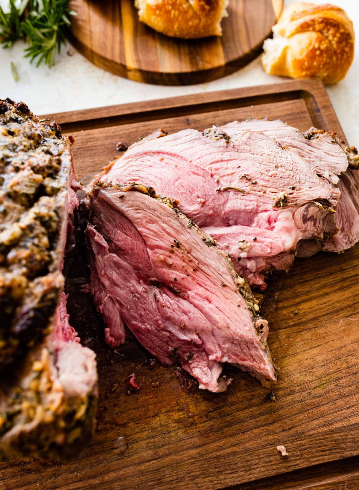 pieces of cut meat on a cutting board. The perfect roast leg of lamb is roasted to perfection.