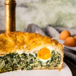 Torta pasqualina - savory Italian Easter pie - sliced in half showing an egg.