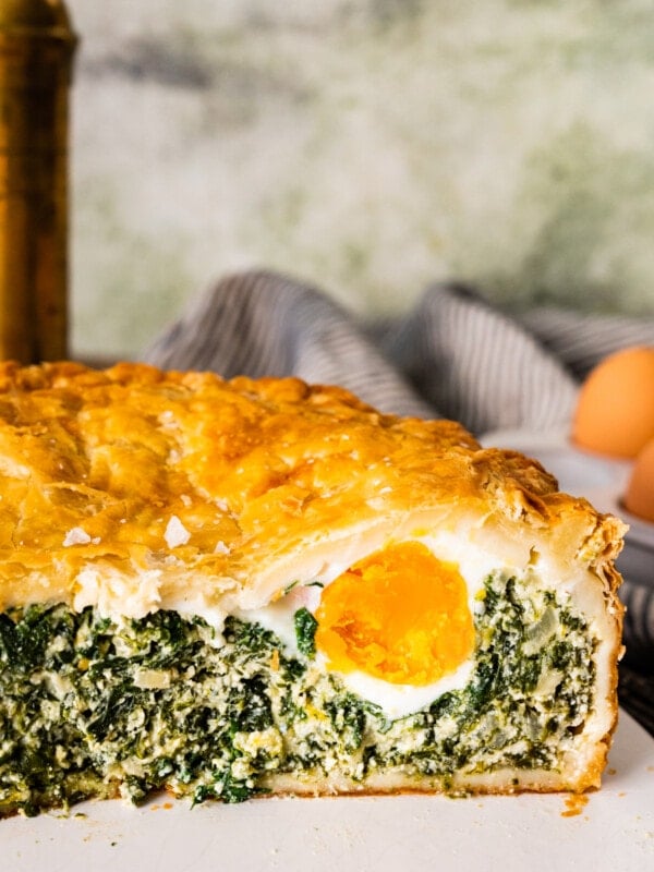 Torta pasqualina - savory Italian Easter pie - sliced in half showing an egg.