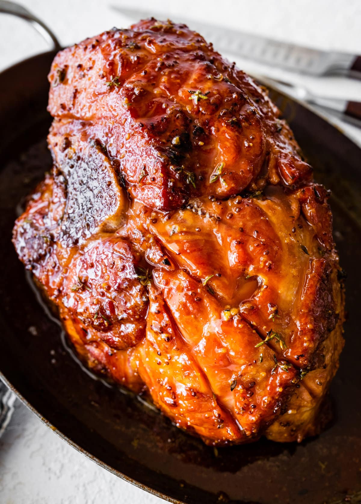 Perfectly baked ham with brown sugar glaze in a large baking dish.