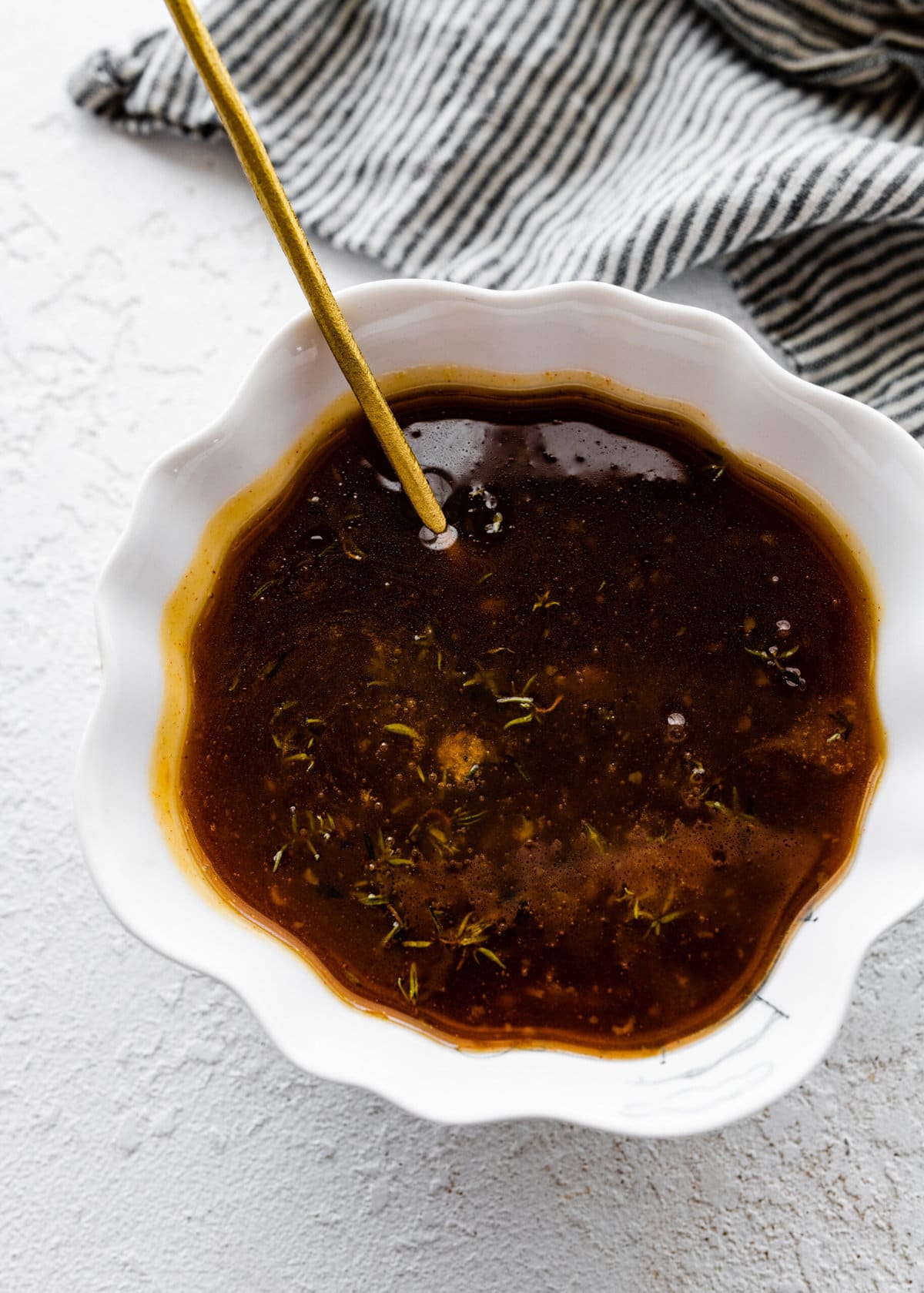 How to make baked ham with brown sugar glaze step-by-step: letting the glaze thicken in a bowl.