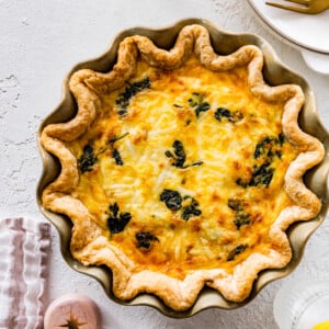 Spinach quiche in a fluted pan.