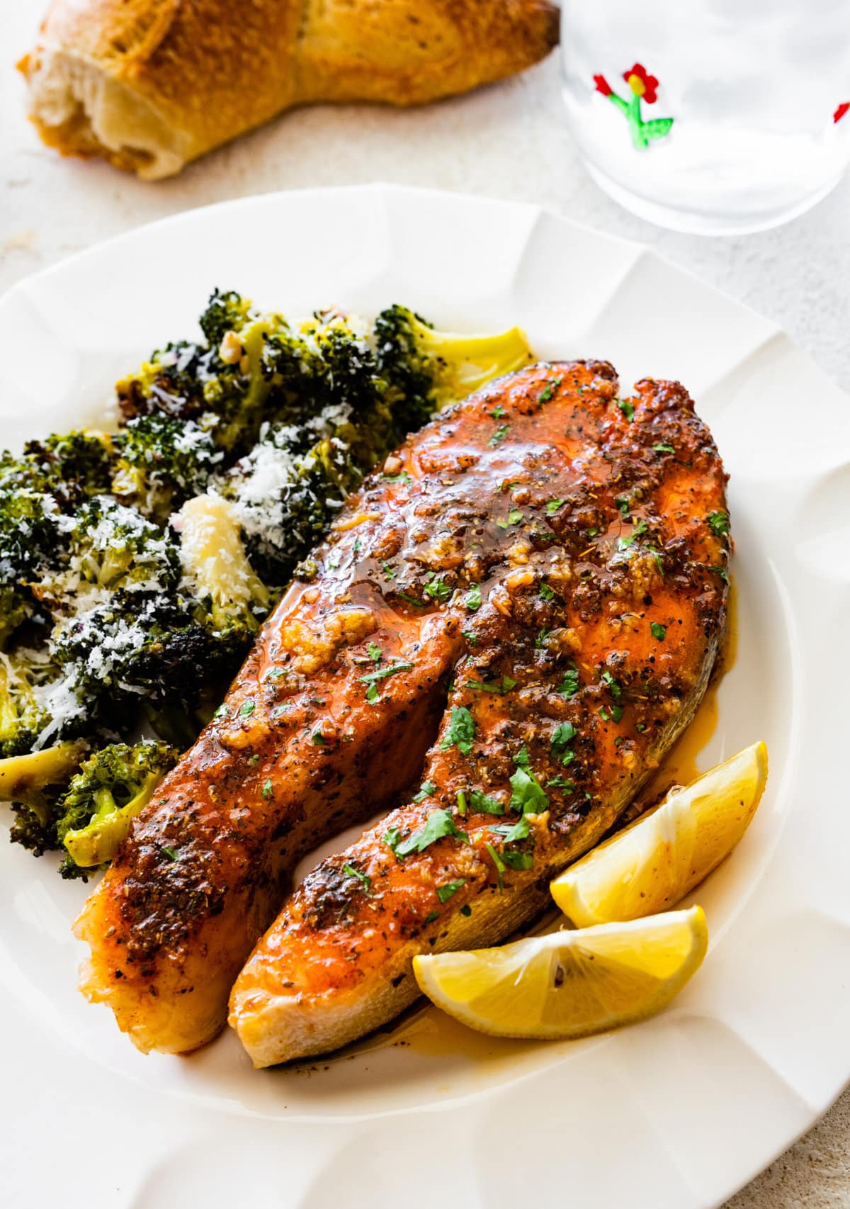 A plate with the easy oven baked salmon steaks recipe with roasted broccoli on the side.