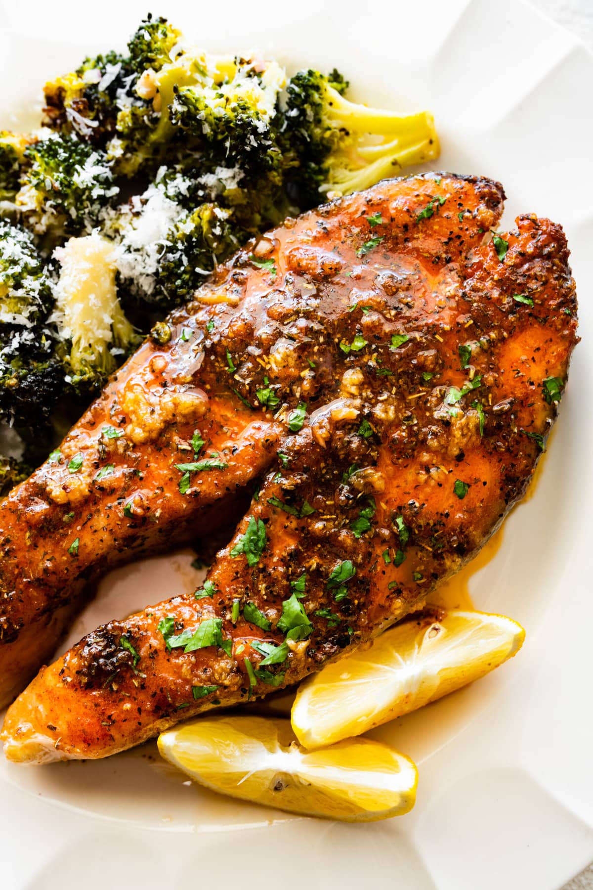 A plate with the easy oven baked salmon steaks recipe with roasted broccoli on the side.