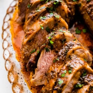 Slices of pork tenderloin on a tray.