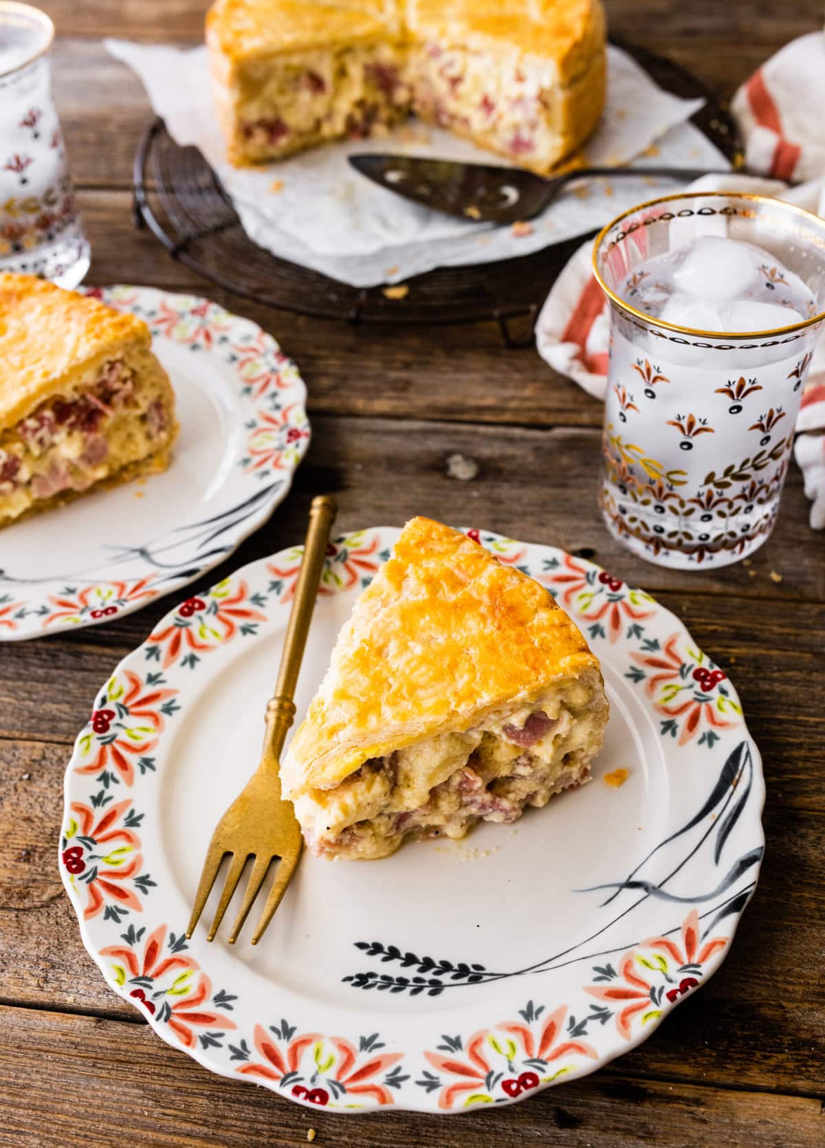 pizza rustica slice on a plate with fork ready to eat.