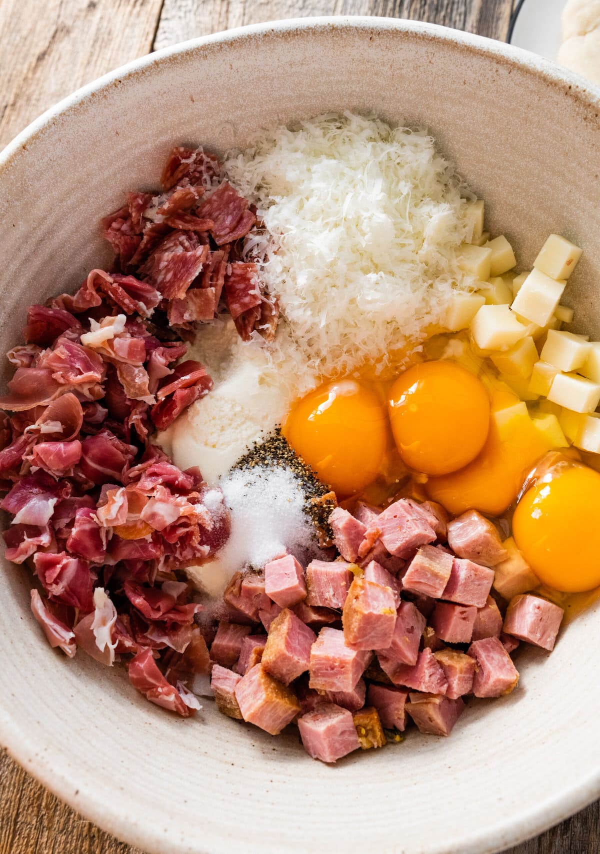 How to make authentic pizza rustica step-by-step: mixing all the filling ingredients in a bowl.