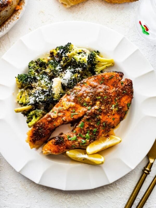 A plate with the easy oven baked salmon steaks recipe with roasted broccoli on the side.