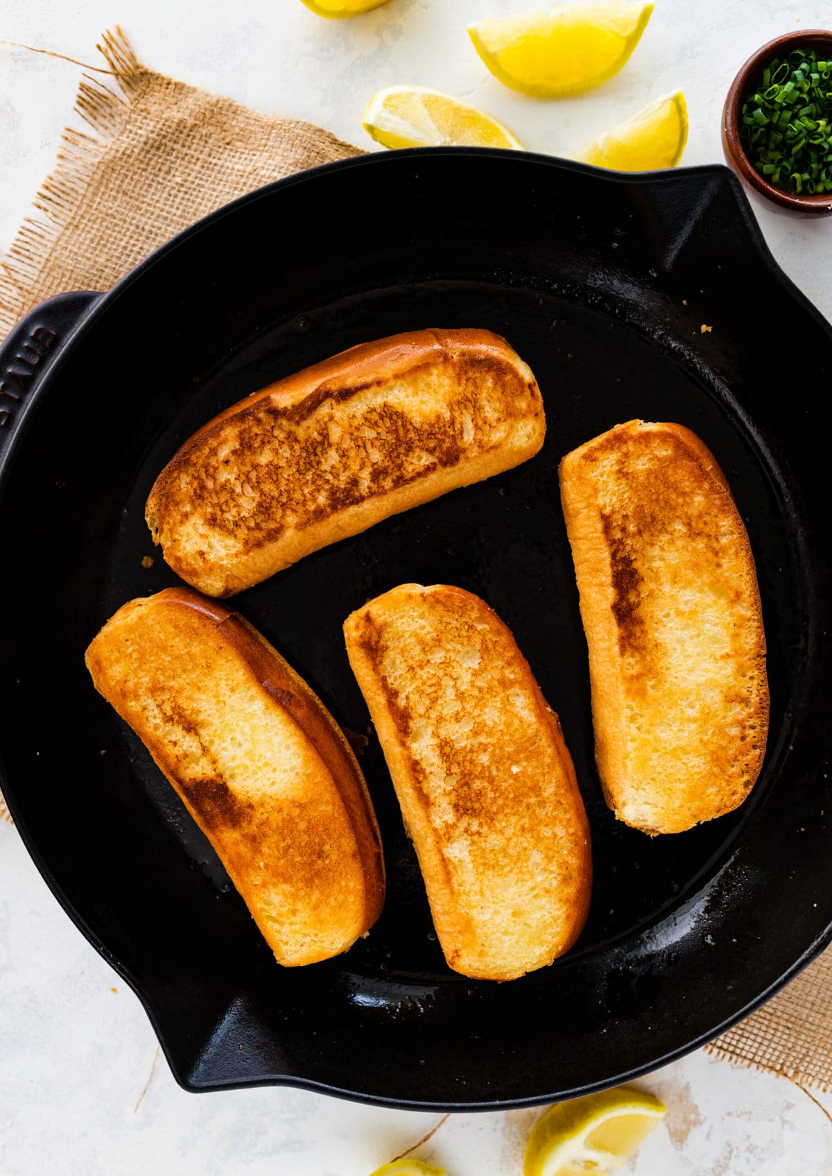 How to make amazing langostino lobster rolls step-by-step instructions: toasting the bread buns.