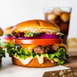 best hamburger recipe ever perfect juicy burger- close up with sauce dripping down the side.