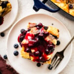 Fork on a plate with a slice of blueberry French toast casserole.