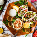 platter with falafel pitas and sides.