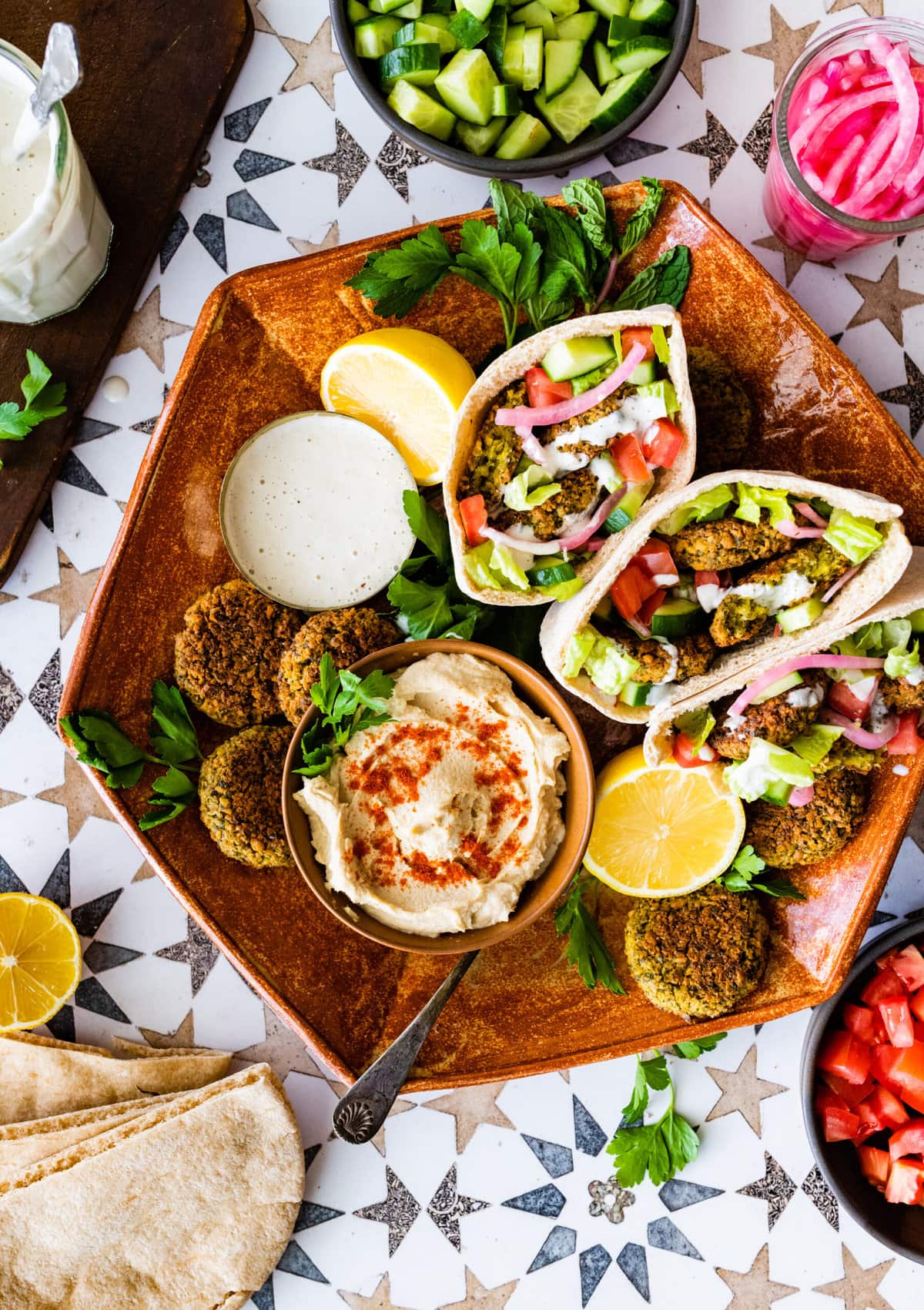platter with falafel pitas and sides.