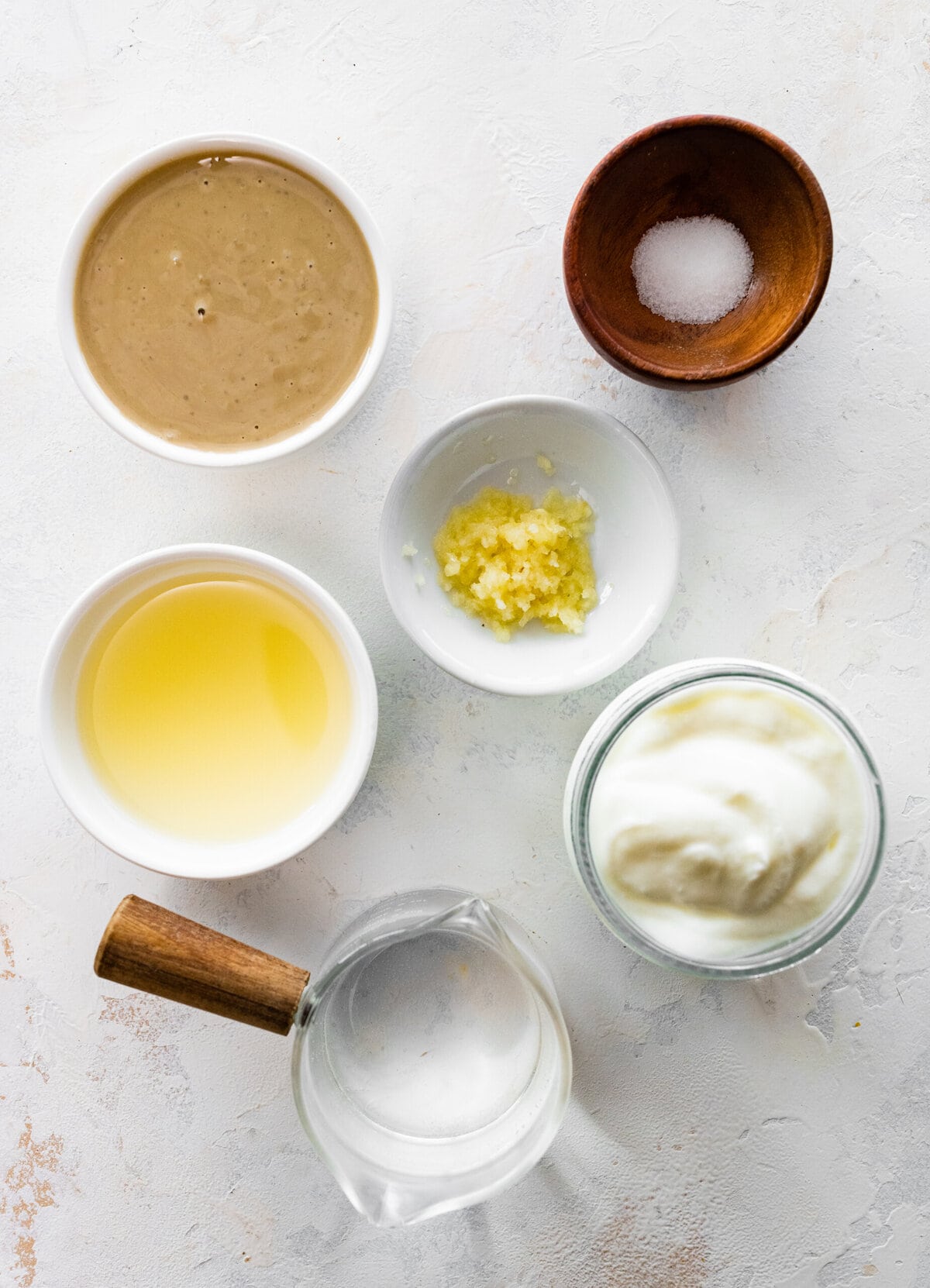 Tahini sauce ingredients including Greek yogurt, lemon juice, and tahini.