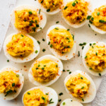 Deviled eggs on a white board.