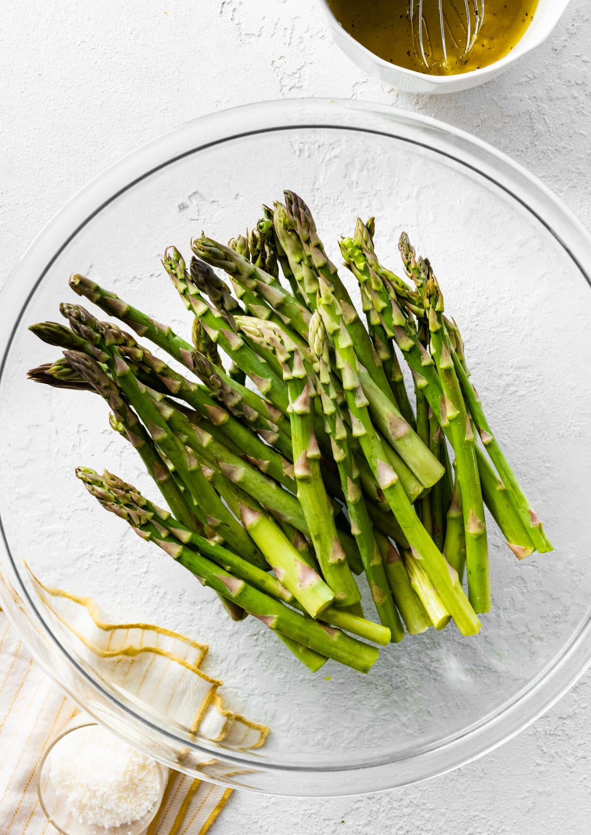 how to make Easy best oven-roasted asparagus recipe (step-by-step instructions)- add ingredients to a bowl.