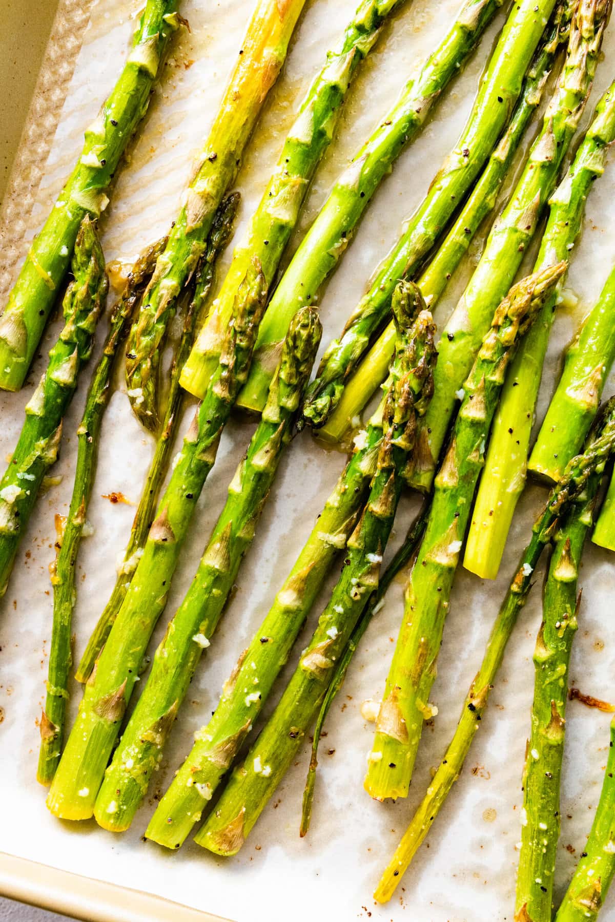 how to make Easy best oven-roasted asparagus recipe (step-by-step instructions)- placing the asparagus on a baking sheet to cook.