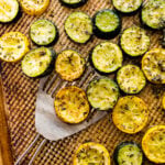 how to make easy oven roasted zucchini instructions: platting the zucchini. on a serving platter with a metal spatula.